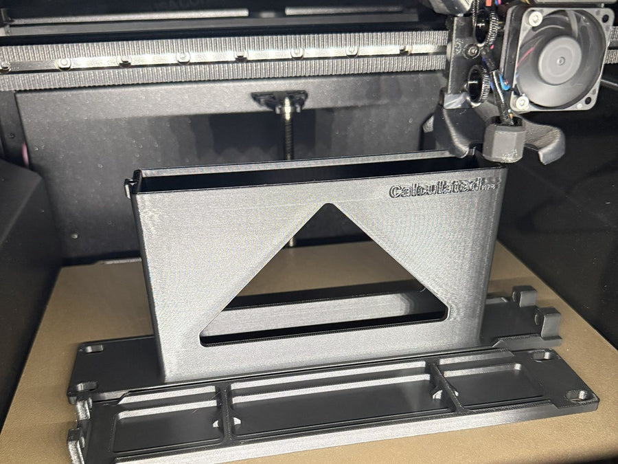 A freshly printed mount on the bed of a Prusa Core One L
